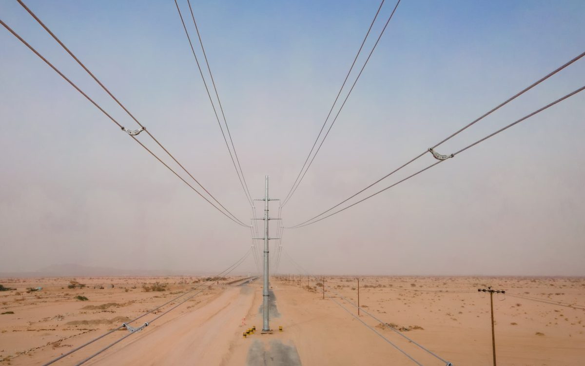 Conductors of the completed 33kV overhead line running away across the desert