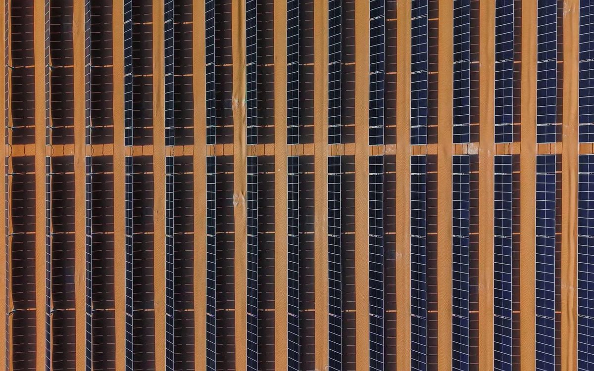 Long rows of solar modules on tracker frames at the SNOC plant in Sharjah