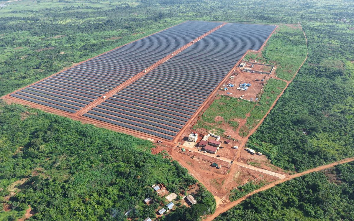 The Sakai II plant seen from the air, its array set into cleared red-earth ground surrounded by forest