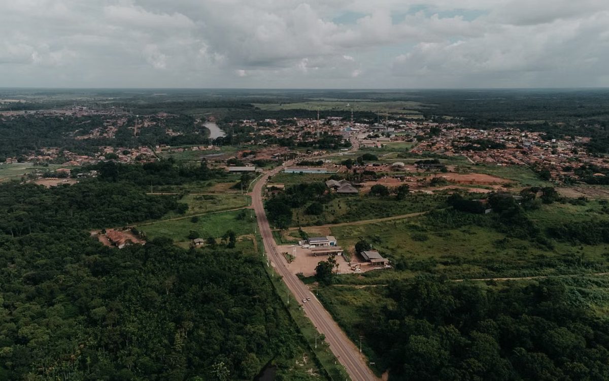 Aerial view over Libreville, its buildings spread across green ground toward the horizon