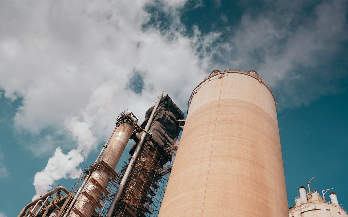 A gas power plant and its stacks on open coastal ground