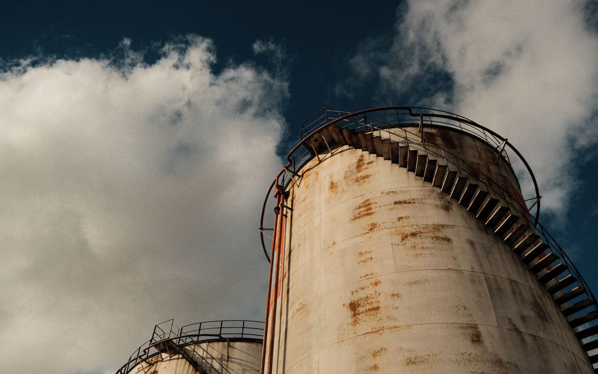 A power plant stack and steam plume seen from below