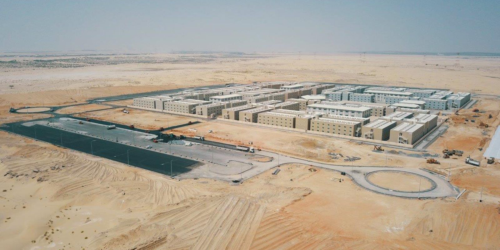 Aerial view of the Razeen labour cities development, rows of accommodation blocks and their access roads