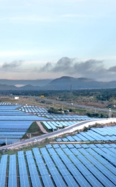 Utility-scale solar arrays running across a valley