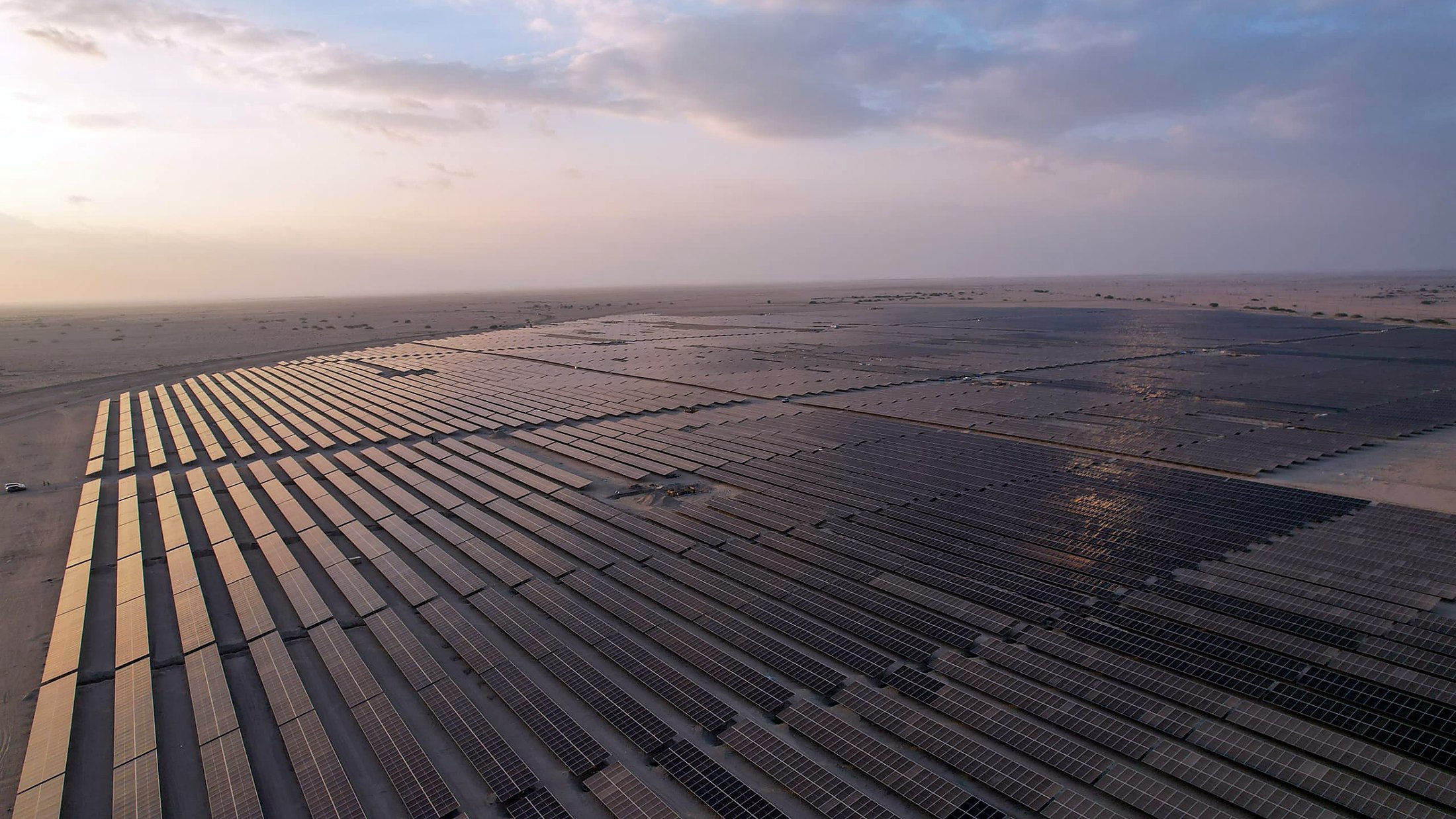 Solar array blocks and a substation seen together from the air