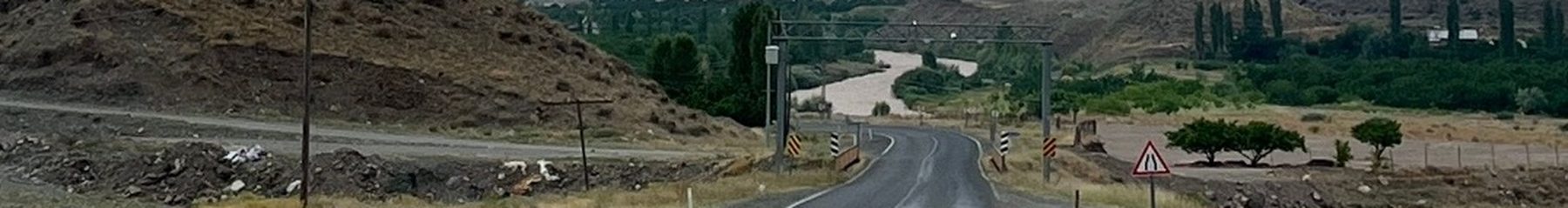 A road cutting through open terrain