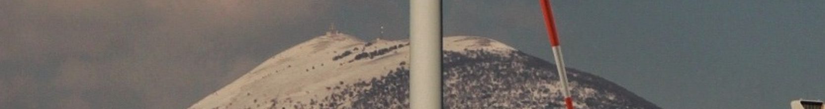 A wind turbine blade against a hillside