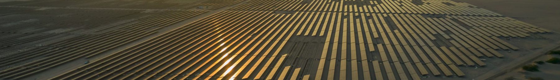 Aerial view of a utility-scale solar array at sunset